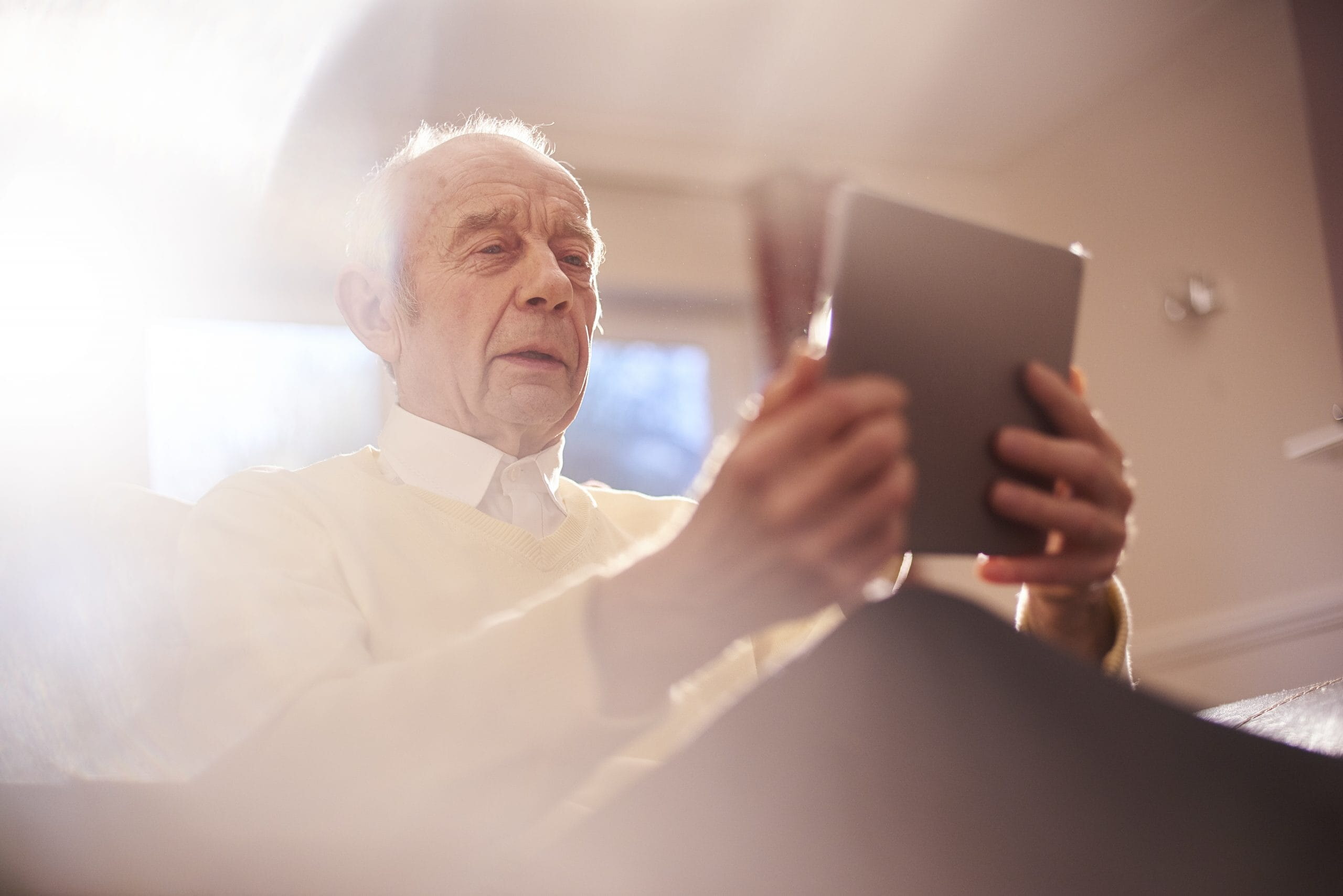 senior man learning to use his digital tablet